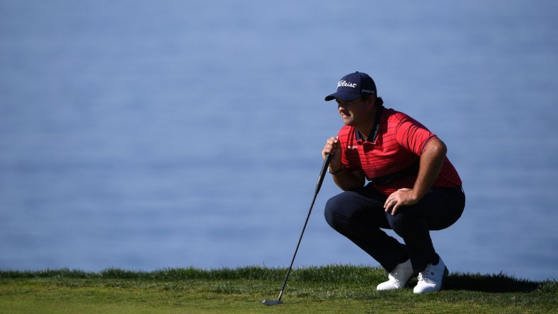 Jan 31, 2021; San Diego, California, USA; Patrick Reed lines up a putt on the second green during the final round of the Farmers Insurance Open golf tournament at Torrey Pines Municipal Golf Course - South Course. Mandatory Credit: Orlando Ramirez-USA TODAY Sports