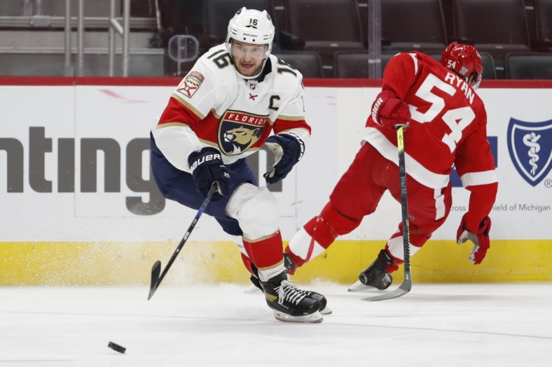 Jan 31, 2021; Detroit, Michigan, USA; Florida Panthers center Aleksander Barkov (16) skates to the puck against Detroit Red Wings right wing Bobby Ryan (54) during the second period at Little Caesars Arena. Mandatory Credit: Raj Mehta-USA TODAY Sports