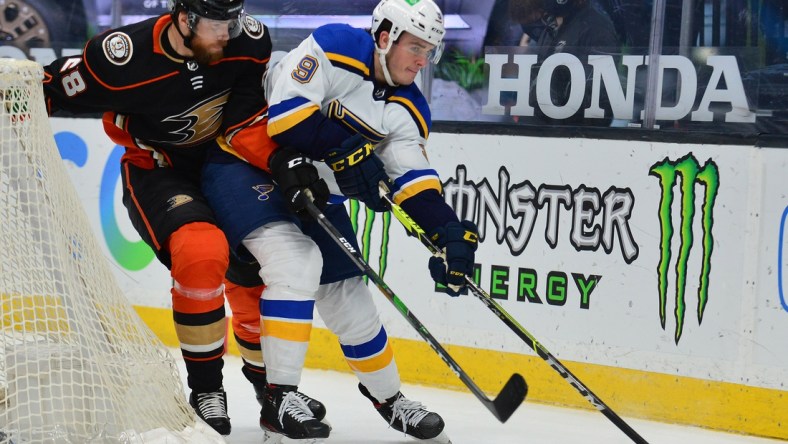 Jan 31, 2021; Anaheim, California, USA; St. Louis Blues left wing Sammy Blais (9) moves the puck against Anaheim Ducks defenseman Jani Hakanpaa (28) during the second period at Honda Center. Mandatory Credit: Gary A. Vasquez-USA TODAY Sports