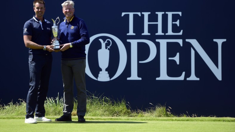 Jul 17, 2017; Southport, ENG; Henrik Stenson (SWE) pose with the Claret Jug and Martin Slumbers, Chief Executive of the R&A during a practice round of The 146th Open Championship golf tournament at Royal Birkdale Golf Club. Mandatory Credit: Thomas J. Russo-USA TODAY Sports