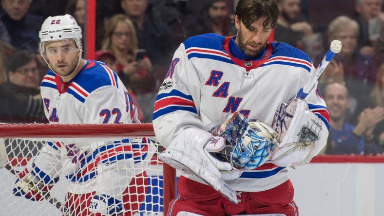 Dec 13, 2017; Ottawa, Ontario, CAN; New York Rangers goalie Henrik Lundqvist (30) adjusts his mask after making a save on a shot from Ottawa Senators left wing Ryan Dzingel (not pictured) in the second period at Canadian Tire Centre. Mandatory Credit: Marc DesRosiers-USA TODAY Sports