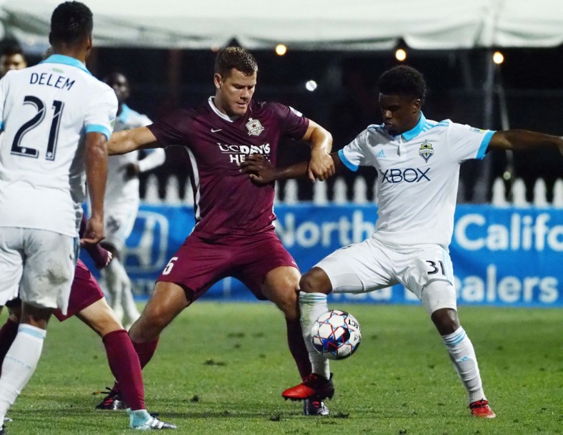 Jun 6, 2018; Sacramento, CA, USA; Sacramento Republic FC defender Justin Schmidt (5) and Seattle Sounders Nick Hinds (31) battle for the ball during the second half at Papa Murphy's Park. Mandatory Credit: Kelley L Cox-USA TODAY Sports