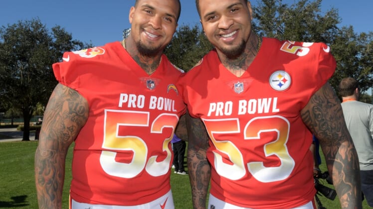 Jan 25, 2019; Kissimmee, FL, USA; Twin brothers and centers Mike Pouncey of the Los Angeles Chargers (left) and Maurkice Pouncey of the Pittsburgh Steelers pose during AFC practice at ESPN Wide World of Sports Complex. Mandatory Credit: Kirby Lee-USA TODAY Sports