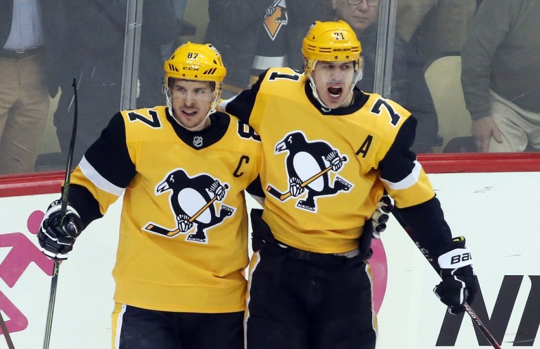 Mar 12, 2019; Pittsburgh, PA, USA;  Pittsburgh Penguins center Sidney Crosby (87) celebrates with center Evgeni Malkin (71) after scoring a goal against the Washington Capitals during the second period at PPG PAINTS Arena. Mandatory Credit: Charles LeClaire-USA TODAY Sports