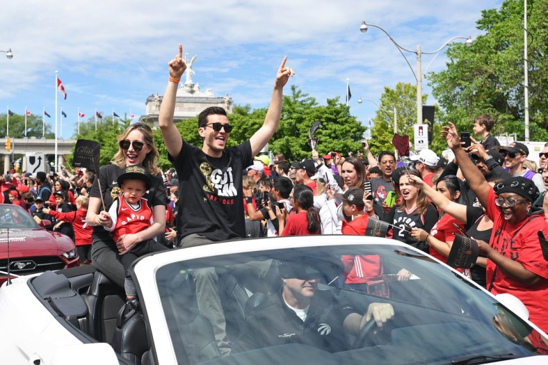 Jun 17, 2019; Toronto, Ontario, Canada; Toronto raptors general Manager Bobby Webster and his family celebrate with fans during the Toronto Raptors Championship Parade on Lakeshore Boulevard. Mandatory Credit: Gerry Angus-USA TODAY Sports