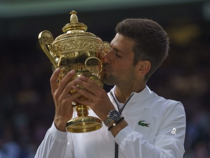 Jul 14, 2019; London, United Kingdom; Novak Djokovic (SRB) poses with the trophy after his mens final match against Roger Federer (SUI) on day 13 at the All England Lawn and Croquet Club. Mandatory Credit: Susan Mullane-USA TODAY Sports