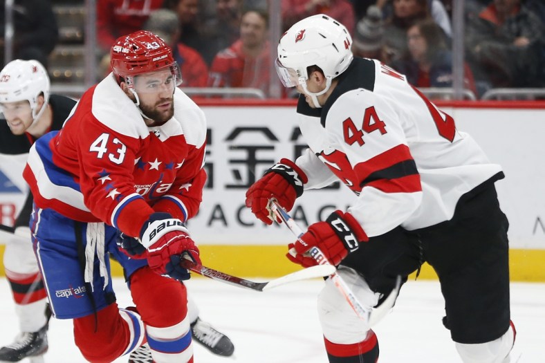 Jan 16, 2020; Washington, District of Columbia, USA; Washington Capitals right wing Tom Wilson (43) slashes New Jersey Devils left wing Miles Wood (44) in the first period at Capital One Arena. Mandatory Credit: Geoff Burke-USA TODAY Sports