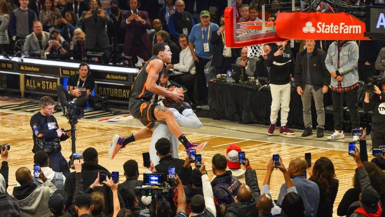 February 15, 2020; Chicago, Illinois, USA; Orlando Magic player Aaron Gordon (top) and Boston Celtics center Tacko Fall (bottom) in the slam dunk contest during NBA All Star Saturday Night at United Center. Mandatory Credit: Kyle Terada-USA TODAY Sports