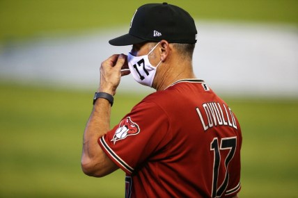 Jul 3, 2020; Phoenix, AZ, USA; Arizona Diamondbacks manager Torey Lovullo adjusts his mask during summer camp workouts at Chase Field. Major League Baseball workouts officially started on Friday after the COVID-19 coronavirus pandemic shuttered spring training in March. Mandatory Credit: Rob Schumacher/The Arizona Republic via USA TODAY NETWORK