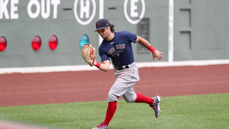 July 10, 2020; Boston, Massachusetts, United States; Boston Red Sox left fielder Andrew Benintendi (16) makes a catch during summer camp practices at Fenway Park. Mandatory Credit: Paul Rutherford-USA TODAY Sports