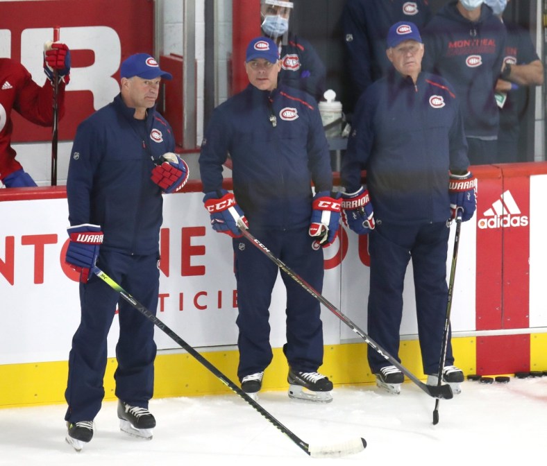 Jul 22, 2020; Montreal, Quebec, CANADA; Montreal Canadiens assistant coaches Kirk Muller (left) and Dominique Ducharme (center) and head coach Claude Julien (right) during a NHL workout at Bell Sports Complex. Mandatory Credit: Jean-Yves Ahern-USA TODAY Sports