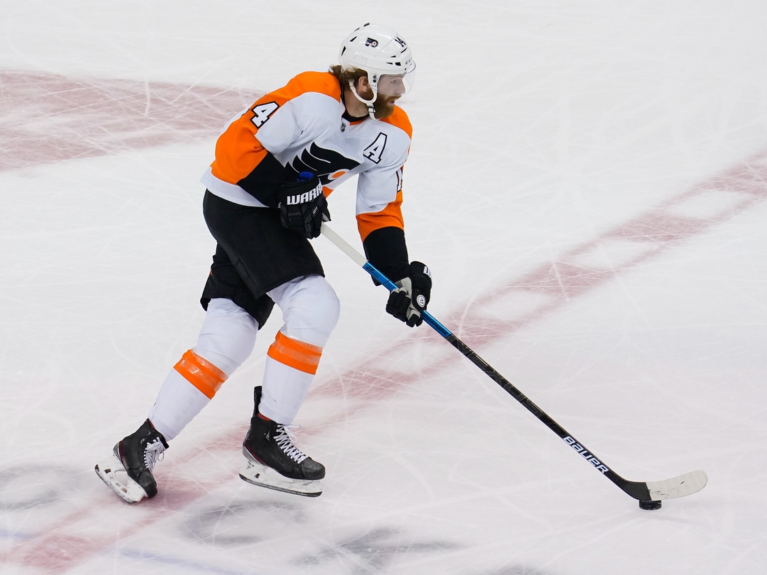 Aug 30, 2020; Toronto, Ontario, CAN; Philadelphia Flyers forward Sean Couturier (14) carries the puck against the New York Islanders in game three of the second round of the 2020 Stanley Cup Playoffs at Scotiabank Arena. Mandatory Credit: John E. Sokolowski-USA TODAY Sports