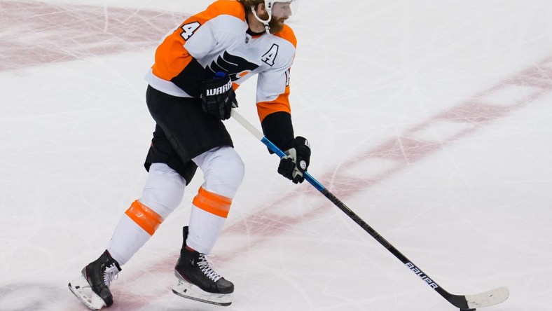 Aug 30, 2020; Toronto, Ontario, CAN; Philadelphia Flyers forward Sean Couturier (14) carries the puck against the New York Islanders in game three of the second round of the 2020 Stanley Cup Playoffs at Scotiabank Arena. Mandatory Credit: John E. Sokolowski-USA TODAY Sports