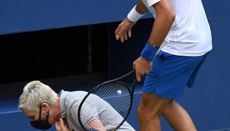 Sep 6, 2020; Flushing Meadows, New York, USA; Novak Djokovic of Serbia checks on a line judge after he unintentionally hit her with a tennis ball after losing a game to Pablo Carreno Busta of Spain (not pictured) on day seven of the 2020 U.S. Open tennis tournament at USTA Billie Jean King National Tennis Center. Mandatory Credit: Danielle Parhizkaran-USA TODAY Sports