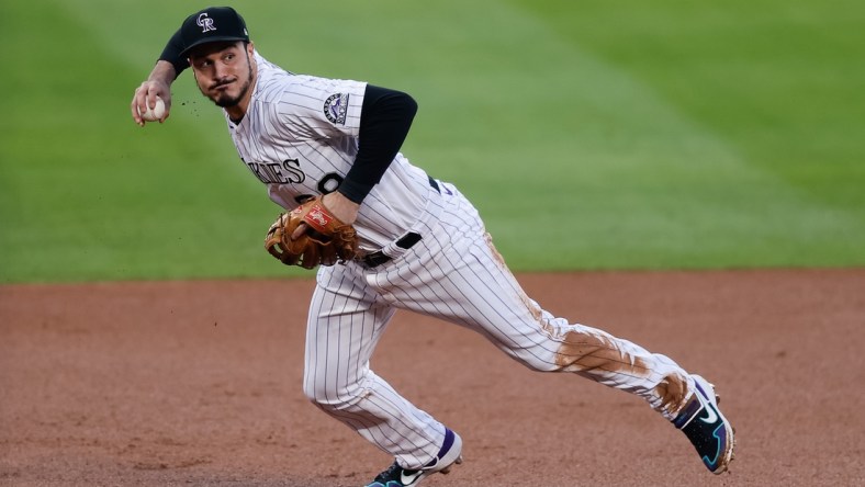 Sep 11, 2020; Denver, Colorado, USA; Colorado Rockies third baseman Nolan Arenado (28) fields and throws to first base in the first inning against the Los Angeles Angels at Coors Field. Mandatory Credit: Isaiah J. Downing-USA TODAY Sports