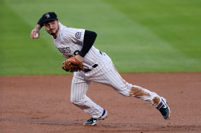 Sep 11, 2020; Denver, Colorado, USA; Colorado Rockies third baseman Nolan Arenado (28) fields and throws to first base in the first inning against the Los Angeles Angels at Coors Field. Mandatory Credit: Isaiah J. Downing-USA TODAY Sports