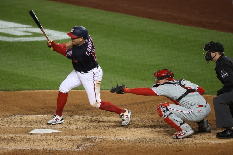 Sep 21, 2020; Washington, District of Columbia, USA; Washington Nationals second baseman Asdrubal Cabrera (13) hits a single against the Philadelphia Phillies in the sixth inning at Nationals Park. Mandatory Credit: Geoff Burke-USA TODAY Sports