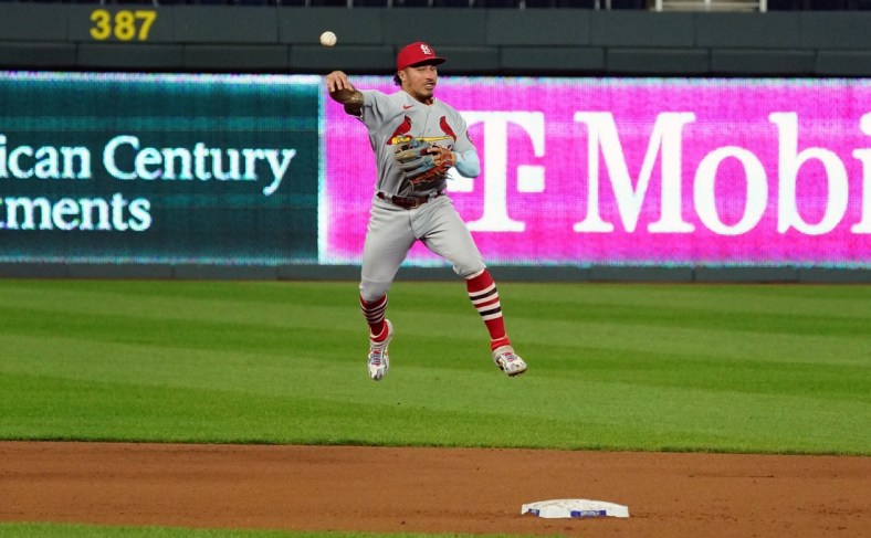 Sep 23, 2020; Kansas City, Missouri, USA; St. Louis Cardinals second baseman Kolten Wong (16) makes a leaping throw to first base for the out against the Kansas City Royals in the fourth inning at Kauffman Stadium. Mandatory Credit: Denny Medley-USA TODAY Sports