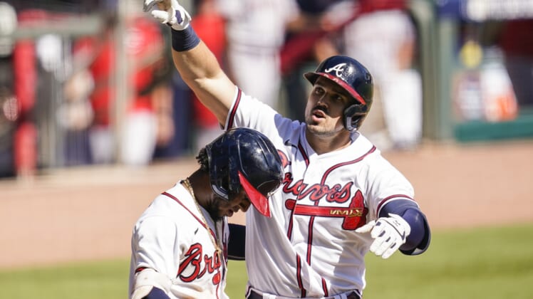 Oct 1, 2020; Cumberland, Georgia, USA; Atlanta Braves left fielder Adam Duvall (23) reacts with second baseman Ozzie Albies (1) after hitting a two run home run against the Cincinnati Reds during the eighth inning at Truist Park. Mandatory Credit: Dale Zanine-USA TODAY Sports
