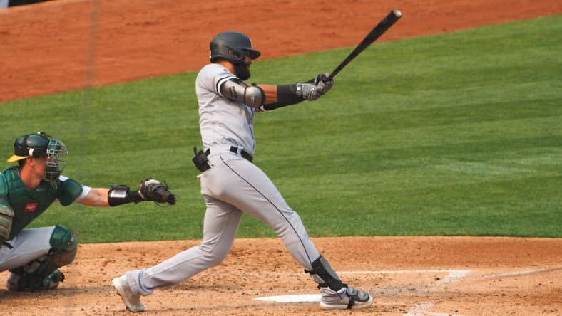 Oct 1, 2020; Oakland, California, USA; Chicago White Sox right fielder Nomar Mazara (30) hits an RBI double against the Oakland Athletics during the third inning at Oakland Coliseum. Mandatory Credit: Kelley L Cox-USA TODAY Sports