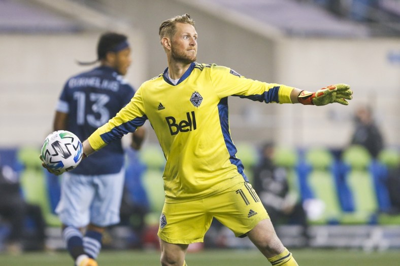 Oct 3, 2020; Seattle, Washington, USA; Vancouver Whitecaps goalkeeper Bryan Meredith (1) throws an outlet pass against the Seattle Sounders FC during the second half at CenturyLink Field. Mandatory Credit: Joe Nicholson-USA TODAY Sports