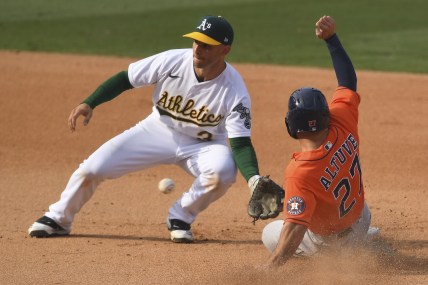 Oct 5, 2020; Los Angeles, California, USA; Oakland Athletics second baseman Tommy La Stella (3) tags out Houston Astros second baseman Jose Altuve (27) on a steal attempt during the eighth inning in game one of the 2020 ALDS at Dodger Stadium. Mandatory Credit: Jayne Kamin-Oncea-USA TODAY Sports