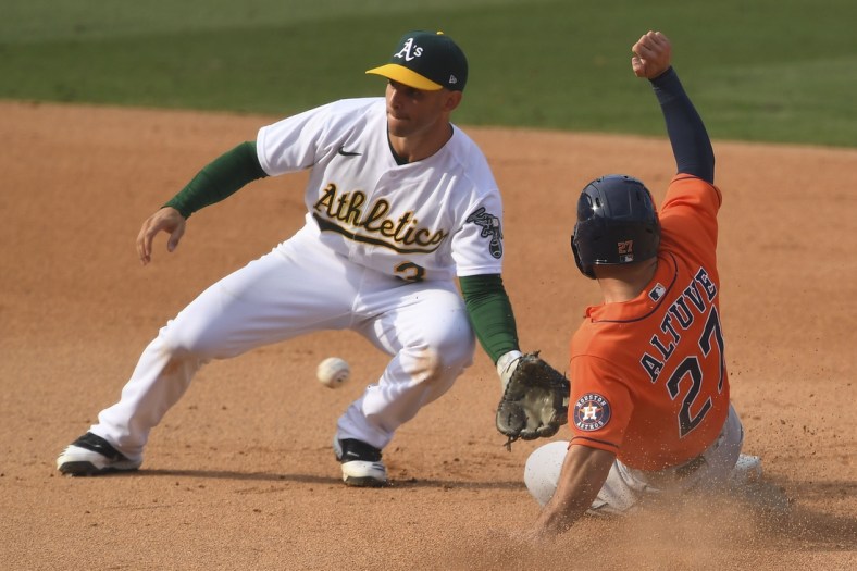 Oct 5, 2020; Los Angeles, California, USA; Oakland Athletics second baseman Tommy La Stella (3) tags out Houston Astros second baseman Jose Altuve (27) on a steal attempt during the eighth inning in game one of the 2020 ALDS at Dodger Stadium. Mandatory Credit: Jayne Kamin-Oncea-USA TODAY Sports