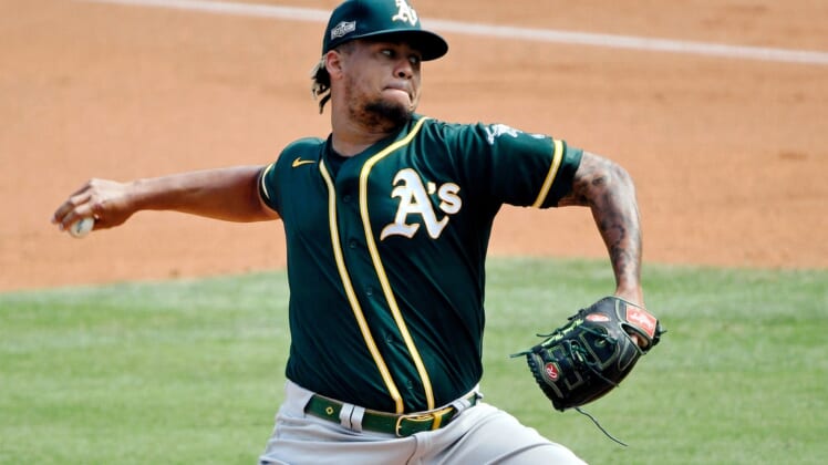 Oct 8, 2020; Los Angeles, California, USA; Oakland Athletics starting pitcher Frankie Montas (47) pitches against the Houston Astros during the first inning during game four of the 2020 ALDS at Dodger Stadium. Mandatory Credit: Robert Hanashiro-USA TODAY Sports