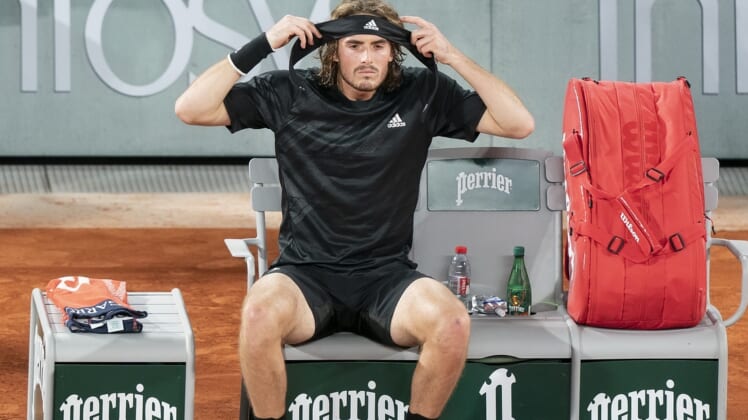 (File photo) Stefanos Tsitsipas (GRE) puts on a new headband at a change of ends during his match against Novak Djokovic (SRB) on day 13 at Stade Roland Garros. Mandatory Credit: Susan Mullane-USA TODAY Sports