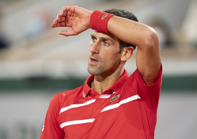 Oct 11, 2020;  Paris, France; Novak Djokovic (SRB) reacts during his match against Rafael Nadal (ESP) on day 15 at Stade Roland Garros. Mandatory Credit: Susan Mullane-USA TODAY Sports