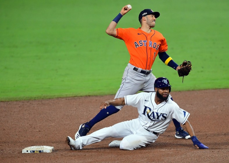 Oct 17, 2020; San Diego, California, USA; Tampa Bay Rays center fielder Manuel Margot (13) is out at second as Houston Astros shortstop Carlos Correa (1) throws to first during the fifth inning  in game seven of the 2020 ALCS at Petco Park. Mandatory Credit: Jayne Kamin-Oncea-USA TODAY Sports