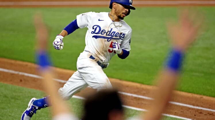 Oct 27, 2020; Arlington, Texas, USA;  Los Angeles Dodgers right fielder Mookie Betts (50) celebrates after hitting a home run during the eighth inning against the Tampa Bay Rays during game six of the 2020 World Series at Globe Life Field. Mandatory Credit: Tim Heitman-USA TODAY Sports