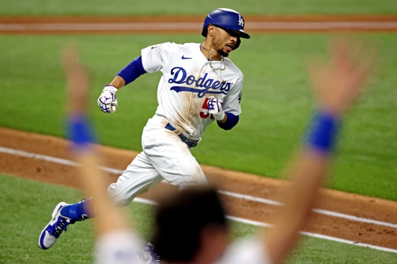 Oct 27, 2020; Arlington, Texas, USA;  Los Angeles Dodgers right fielder Mookie Betts (50) celebrates after hitting a home run during the eighth inning against the Tampa Bay Rays during game six of the 2020 World Series at Globe Life Field. Mandatory Credit: Tim Heitman-USA TODAY Sports