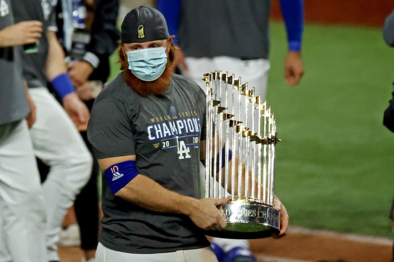 Oct 27, 2020; Arlington, Texas, USA; Los Angeles Dodgers third baseman Justin Turner (10) celebrates with the Commissioner's Trophy after the Los Angeles Dodgers beat the Tampa Bay Rays to win the World Series in game six of the 2020 World Series at Globe Life Field. Mandatory Credit: Kevin Jairaj-USA TODAY Sports
