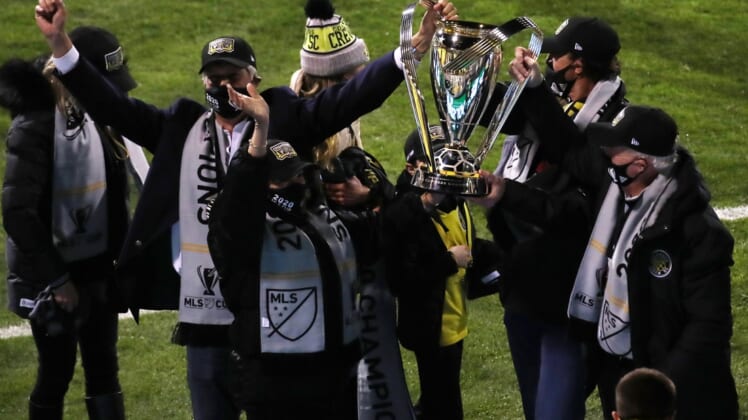 Dec 12, 2020; Columbus, Ohio, USA;  Columbus Crew officials hold the MLS Cup championship trophy after defeating the Seattle Sounders in the 2020 MLS Cup Final at MAPFRE Stadium.  Mandatory Credit: Trevor Ruszkowski-USA TODAY Sports