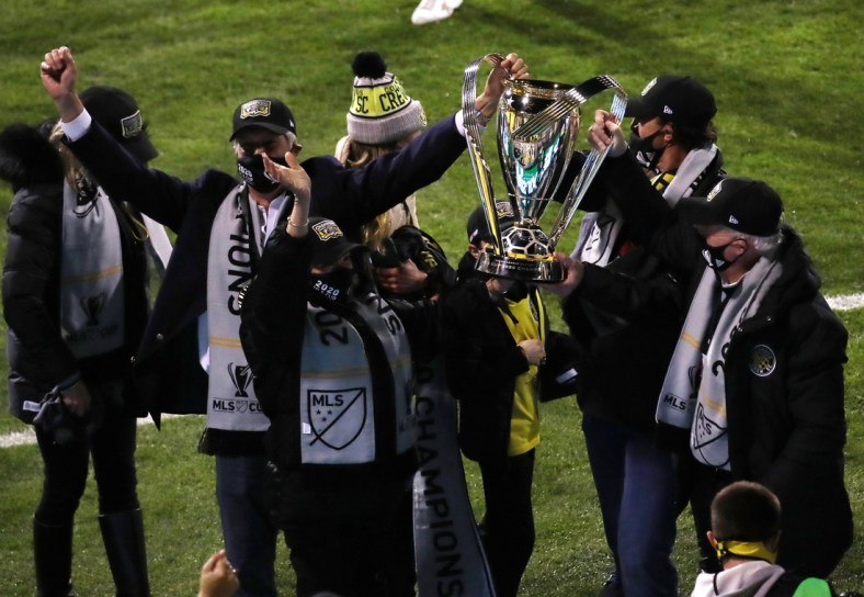 Dec 12, 2020; Columbus, Ohio, USA;  Columbus Crew officials hold the MLS Cup championship trophy after defeating the Seattle Sounders in the 2020 MLS Cup Final at MAPFRE Stadium.  Mandatory Credit: Trevor Ruszkowski-USA TODAY Sports