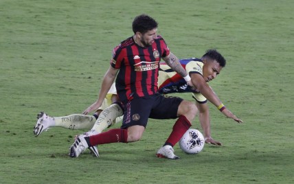 Dec 16, 2020; Orlando, Florida, USA; Atlanta United midfielder Eric Remedi (left) and Club America forward Roger Martinez (right) battle for the ball in the second half during the 2020SCCL quarterfinals at Exploria Stadium. Mandatory Credit: Reinhold Matay-USA TODAY Sports