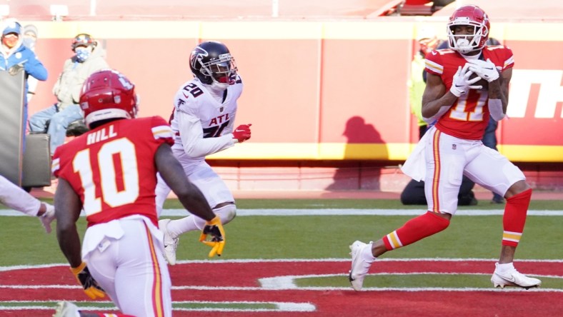 Dec 27, 2020; Kansas City, MO, USA; Kansas City Chiefs wide receiver Demarcus Robinson (11) catches a pass for a touchdown against Atlanta Falcons defensive back Kendall Sheffield (20) in the fourth quarter of a NFL game at Arrowhead Stadium. Mandatory Credit: Denny Medley-USA TODAY Sports