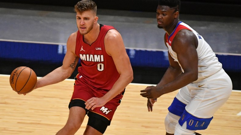 Dec 25, 2020; Miami, Florida, USA; Miami Heat center Meyers Leonard (0) controls the ball around New Orleans Pelicans forward Zion Williamson (1) during the second half at American Airlines Arena. Mandatory Credit: Jasen Vinlove-USA TODAY Sports