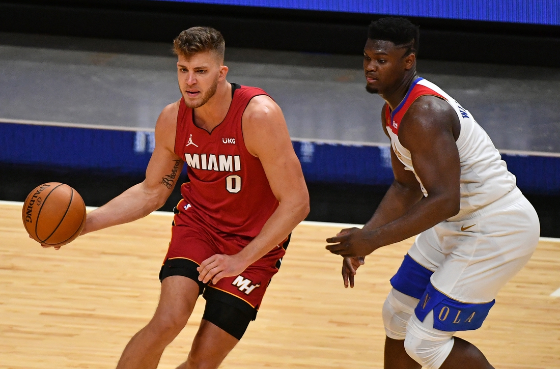 Dec 25, 2020; Miami, Florida, USA; Miami Heat center Meyers Leonard (0) controls the ball around New Orleans Pelicans forward Zion Williamson (1) during the second half at American Airlines Arena. Mandatory Credit: Jasen Vinlove-USA TODAY Sports