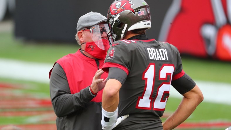 Jan 3, 2021; Tampa, Florida, USA; Tampa Bay Buccaneers head coach Bruce Arians (L) and quarterback Tom Brady (12) talk prior to the game against the Atlanta Falcons at Raymond James Stadium. Mandatory Credit: Kim Klement-USA TODAY Sports