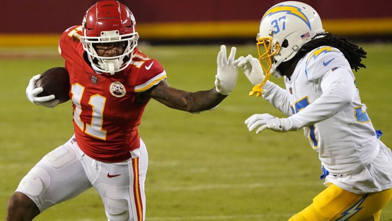 Jan 3, 2021; Kansas City, Missouri, USA; Kansas City Chiefs wide receiver Demarcus Robinson (11) runs the ball against Los Angeles Chargers cornerback Tevaughn Campbell (37) during the second half at Arrowhead Stadium. Mandatory Credit: Jay Biggerstaff-USA TODAY Sports