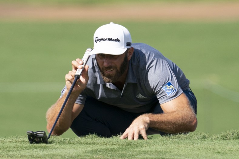 January 9, 2021; Maui, Hawaii, USA; Dustin Johnson lines up his putt on the third hole during the third round of the Sentry Tournament of Champions golf tournament at Kapalua Resort - The Plantation Course. Mandatory Credit: Kyle Terada-USA TODAY Sports