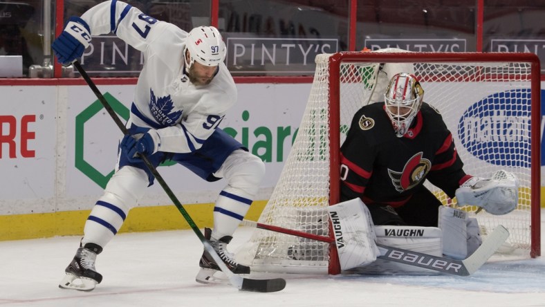 Jan 16, 2021; Ottawa, Ontario, CAN; Toronto Maple Leafs center Joe Thornton (97) moves the puck in front of Ottawa Senators goalie Matt Murray (30) in the first period at the Canadian Tire Centre. Mandatory Credit: Marc DesRosiers-USA TODAY Sports