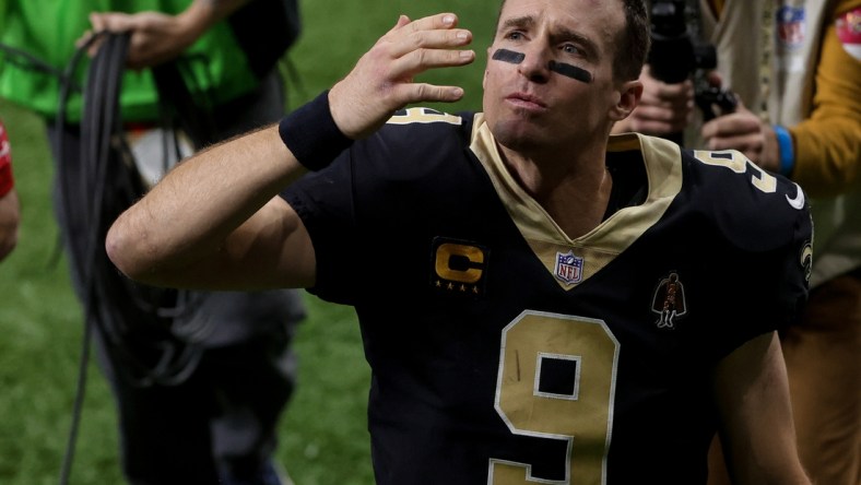 Jan 17, 2021; New Orleans, Louisiana, USA; New Orleans Saints quarterback Drew Brees (9) blows a kiss to his family as he walks to the tunnel following a 30-20 loss against the Tampa Bay Buccaneers in a NFC Divisional Round playoff game at the Mercedes-Benz Superdome. Mandatory Credit: Derick E. Hingle-USA TODAY Sports