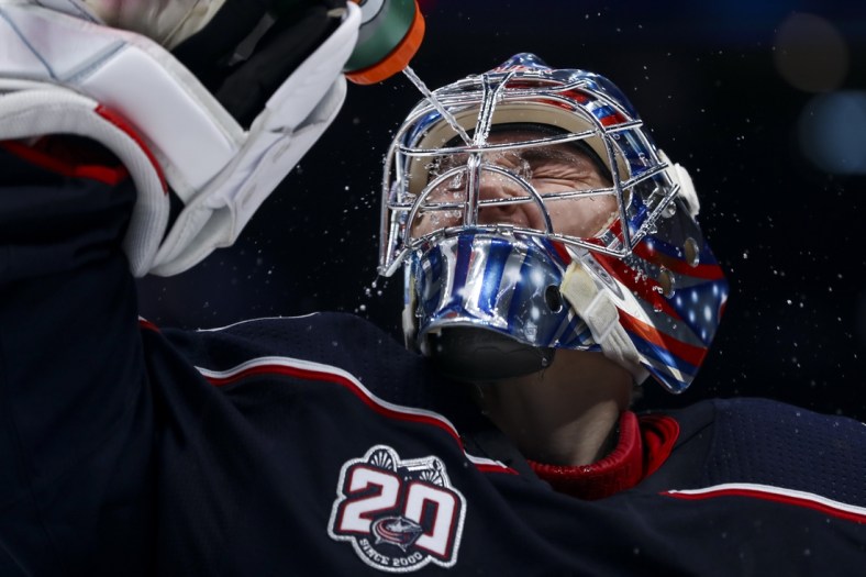 Jan 23, 2021; Columbus, Ohio, USA; Columbus Blue Jackets goaltender Elvis Merzlikins (90) sprays water onto his face prior to the start of the third period against the Tampa Bay Lightning at Nationwide Arena. Mandatory Credit: Aaron Doster-USA TODAY Sports