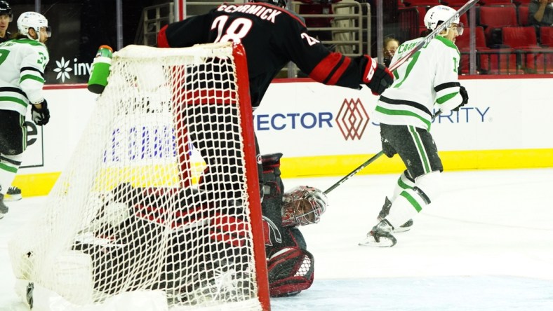 Jan 30, 2021; Raleigh, North Carolina, USA;  Carolina Hurricanes goaltender Petr Mrazek (34) is hurt on a collision with Carolina Hurricanes left wing Max McCormick (28) during the first period at PNC Arena. Mandatory Credit: James Guillory-USA TODAY Sports