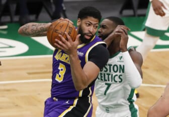 Jan 30, 2021; Boston, Massachusetts, USA; Los Angeles Lakers forward Anthony Davis (3) grabs a rebound from Boston Celtics guard Jaylen Brown (7) during the first quarter at TD Garden. Mandatory Credit: Winslow Townson-USA TODAY Sports
