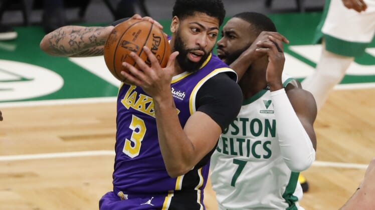 Jan 30, 2021; Boston, Massachusetts, USA; Los Angeles Lakers forward Anthony Davis (3) grabs a rebound from Boston Celtics guard Jaylen Brown (7) during the first quarter at TD Garden. Mandatory Credit: Winslow Townson-USA TODAY Sports