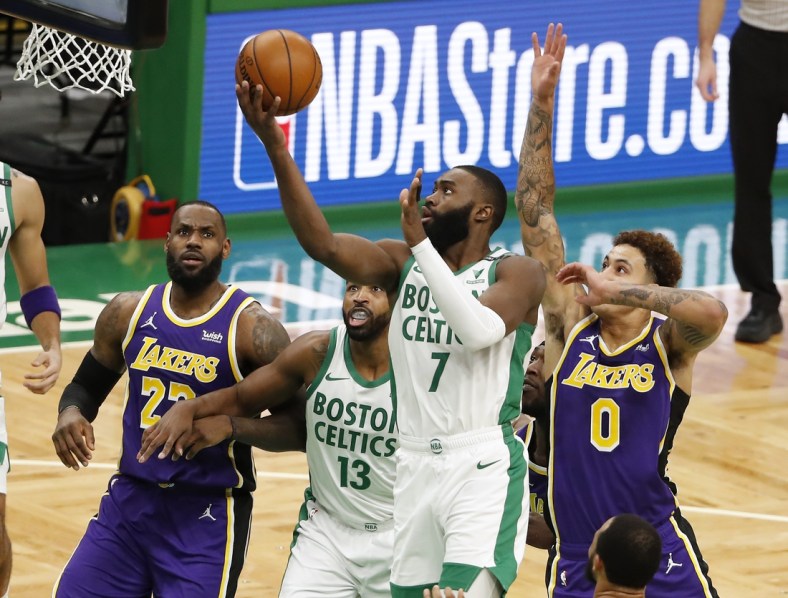 Jan 30, 2021; Boston, Massachusetts, USA; Boston Celtics guard Jaylen Brown (7) goes to the basket as Los Angeles Lakers forward LeBron James (23) looks on during the second quarter at TD Garden. Mandatory Credit: Winslow Townson-USA TODAY Sports